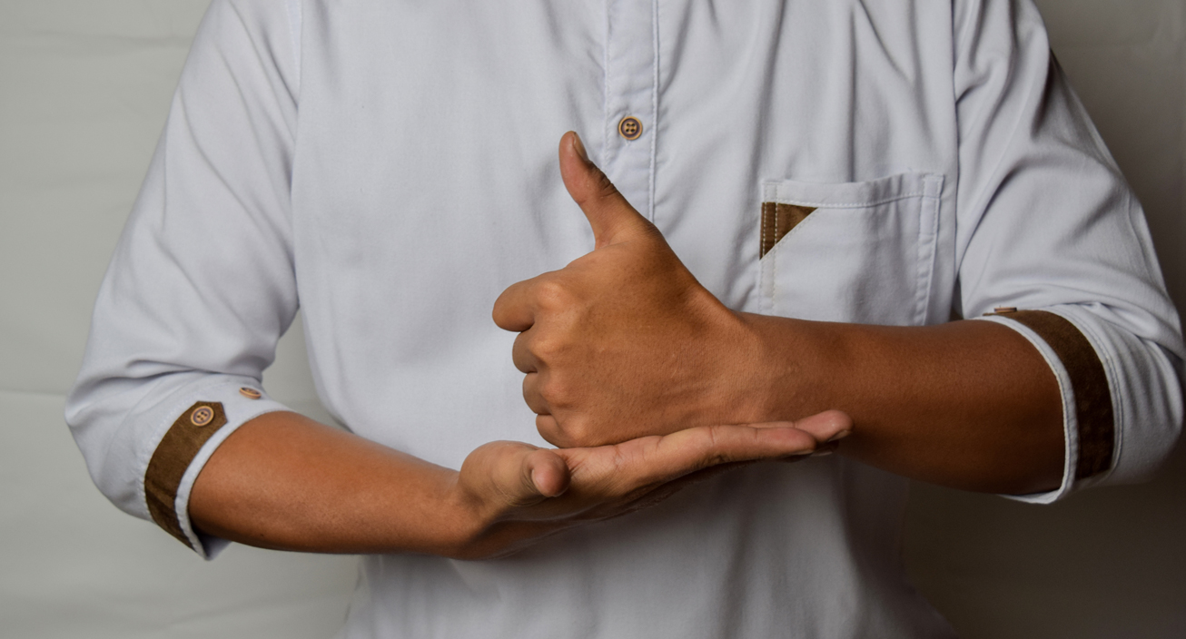 Close up Asian man shows hand gestures it means HELP isolated on white background. American sign language