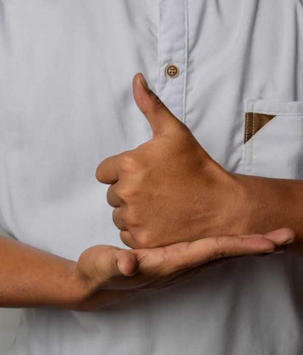 Close up Asian man shows hand gestures it means HELP isolated on white background. American sign language