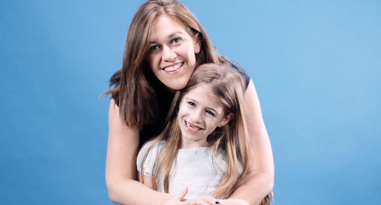 Female Intuit employee smiling with her daughter