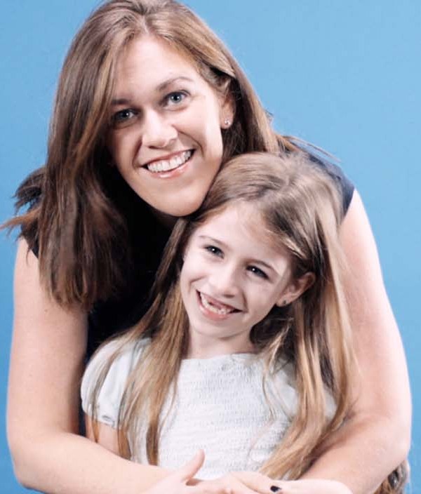 Female Intuit employee smiling with her daughter