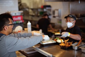 Eric getting ready to serve food in one of his restaurants