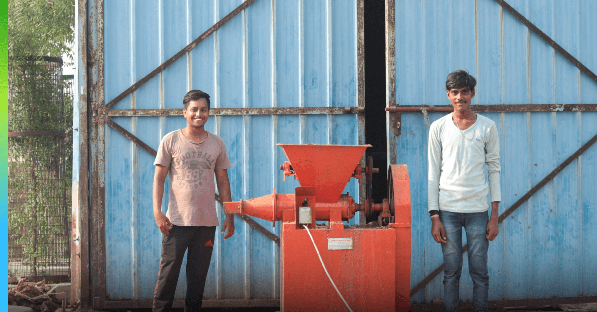 Two students in India smile in front of the camera