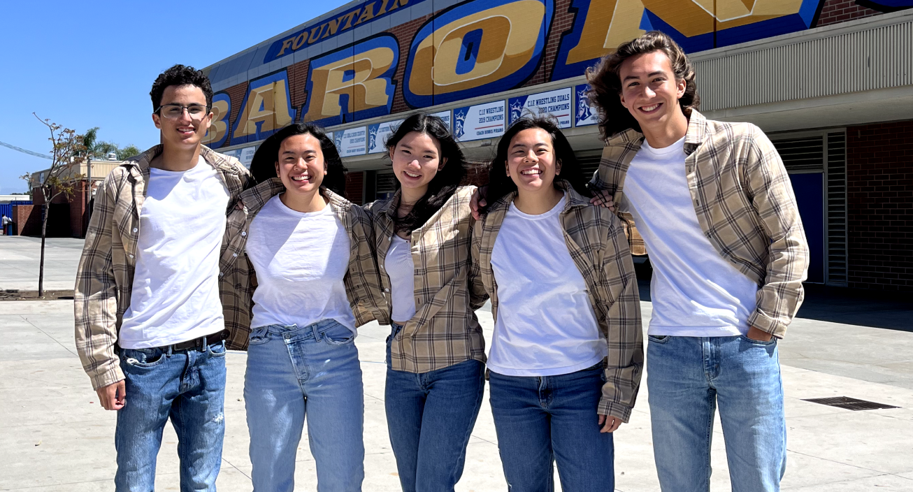 Five high schoolers of various ethnicities pose in tan flannels and white t-shirts.