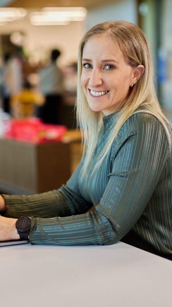 Blonde woman working in an office at her computer.