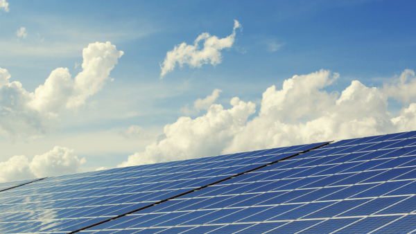 Solar panels with a blue sky and wipsy clouds