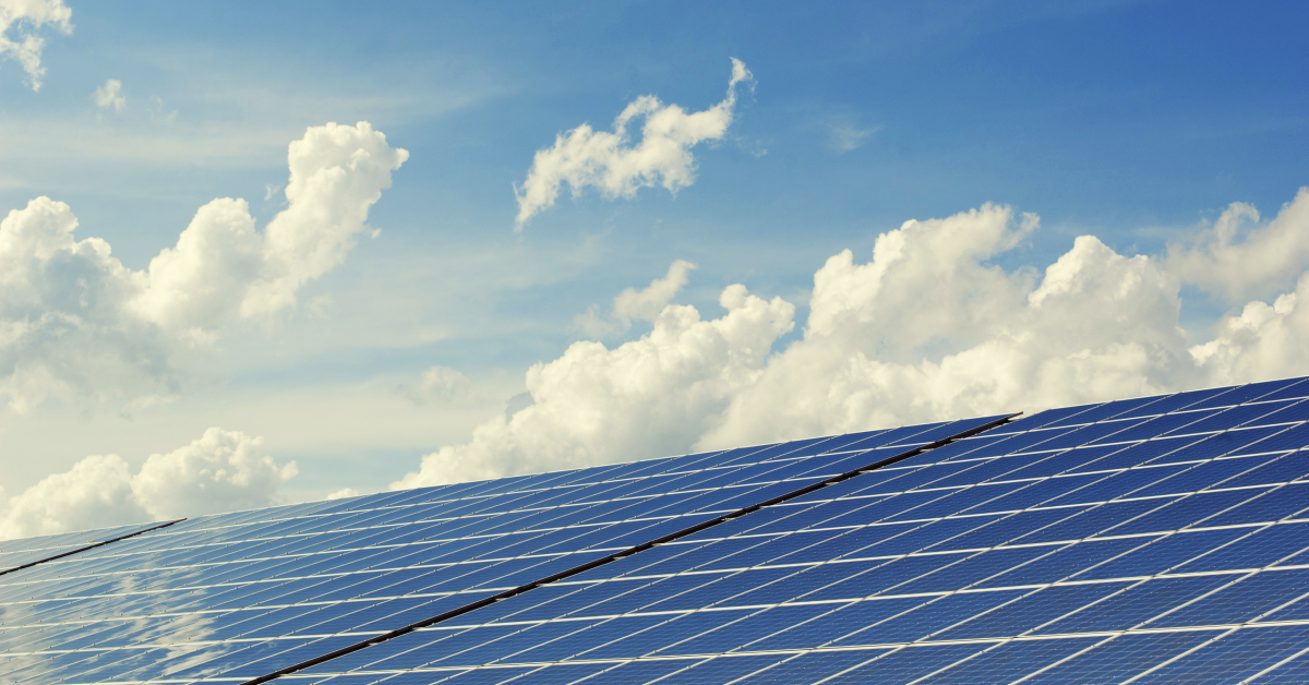 Solar panels with a blue sky and wipsy clouds