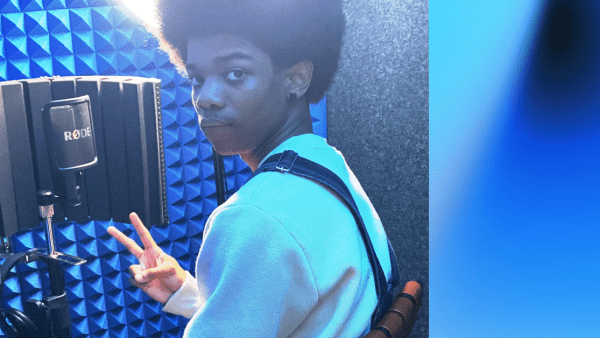 Boy in soundbooth with blue light and recording equipment