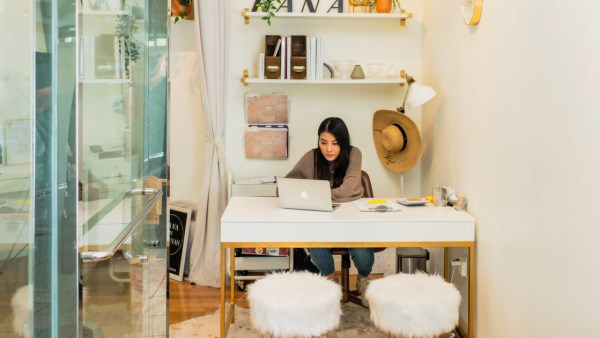 Woman working behind desk.