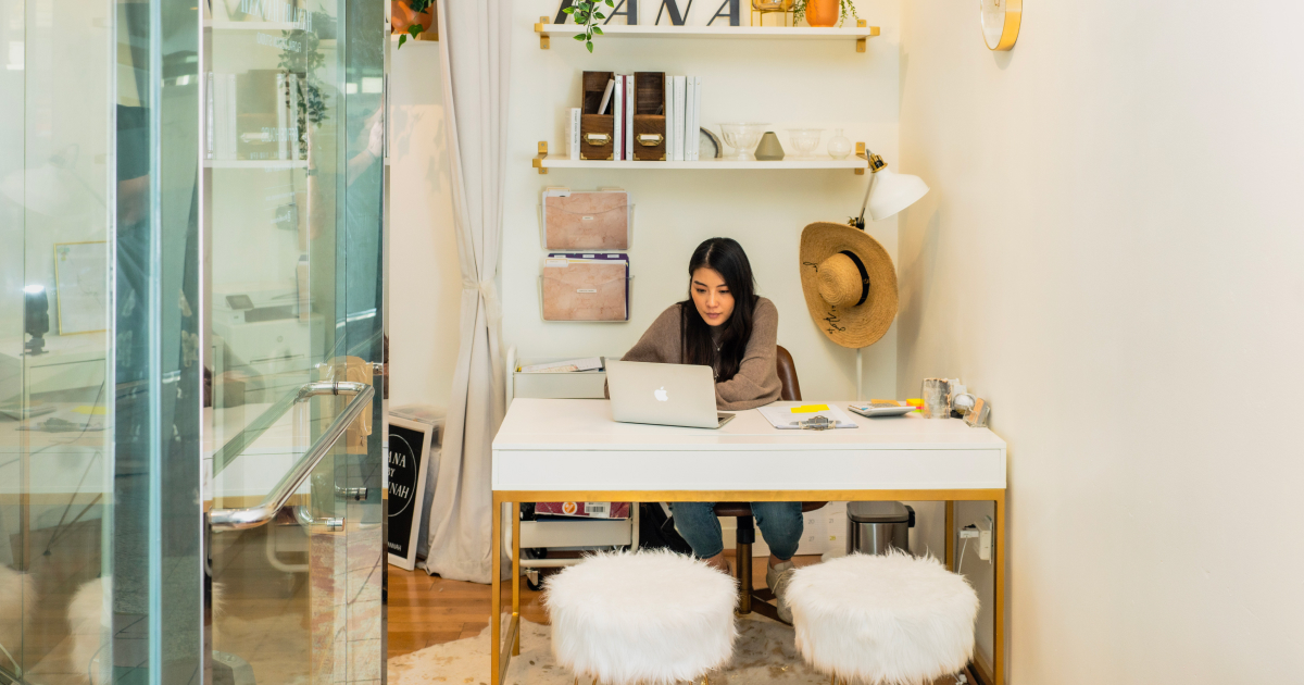 Woman working behind desk.