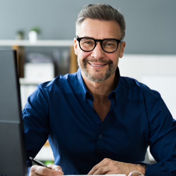 A man reviews financial documents, illustrating the difference between bookkeeping and accounting careers.