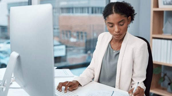 Woman reviews notes while preparing taxes in Texas.