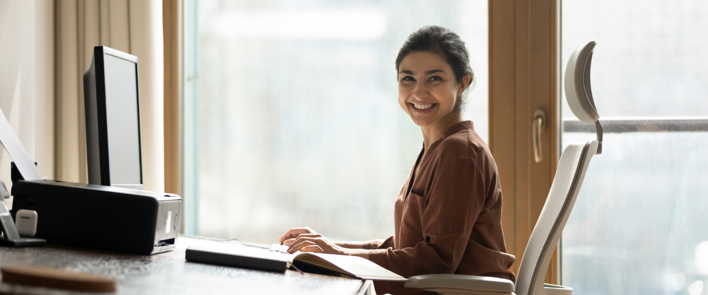 A woman reviews bookkeeping tips and an example resume.