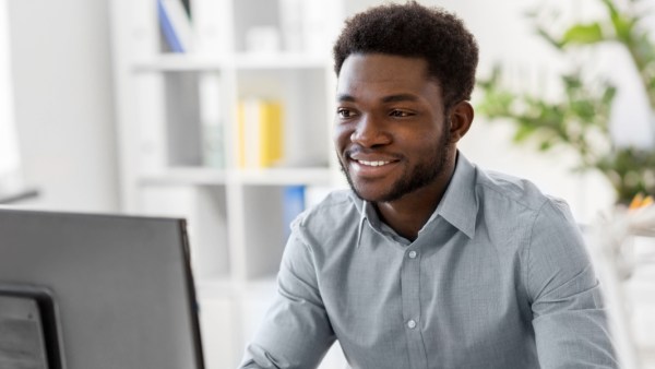 A man studying at the computer to become a tax preparer in California