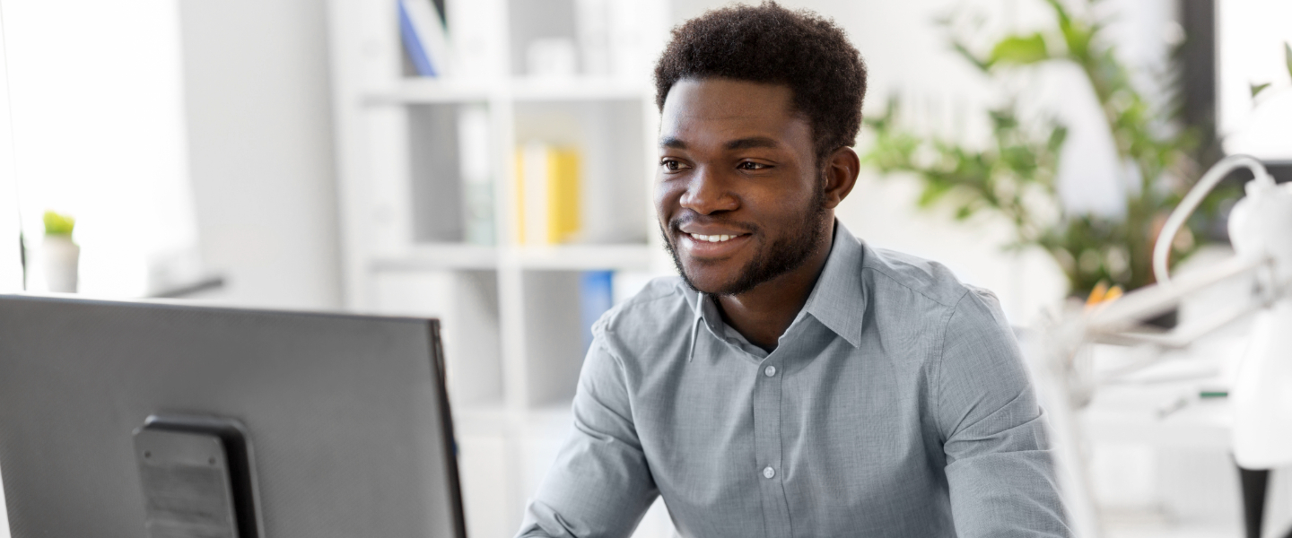 A man studying at the computer to become a tax preparer in California